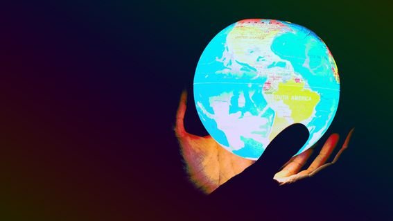 globe held in someone's hand (Greg Rosenke/Unsplash, modified by CoinDesk)